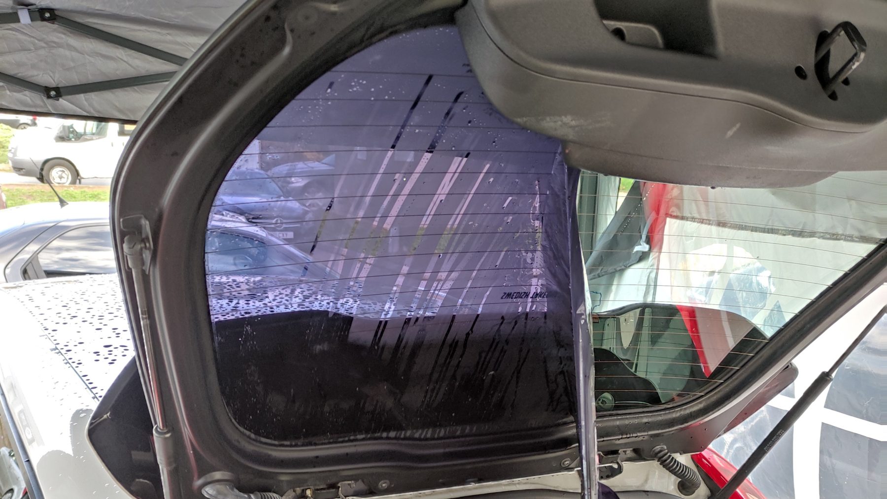 Window Tinting hatchback rear window with tint partially removed