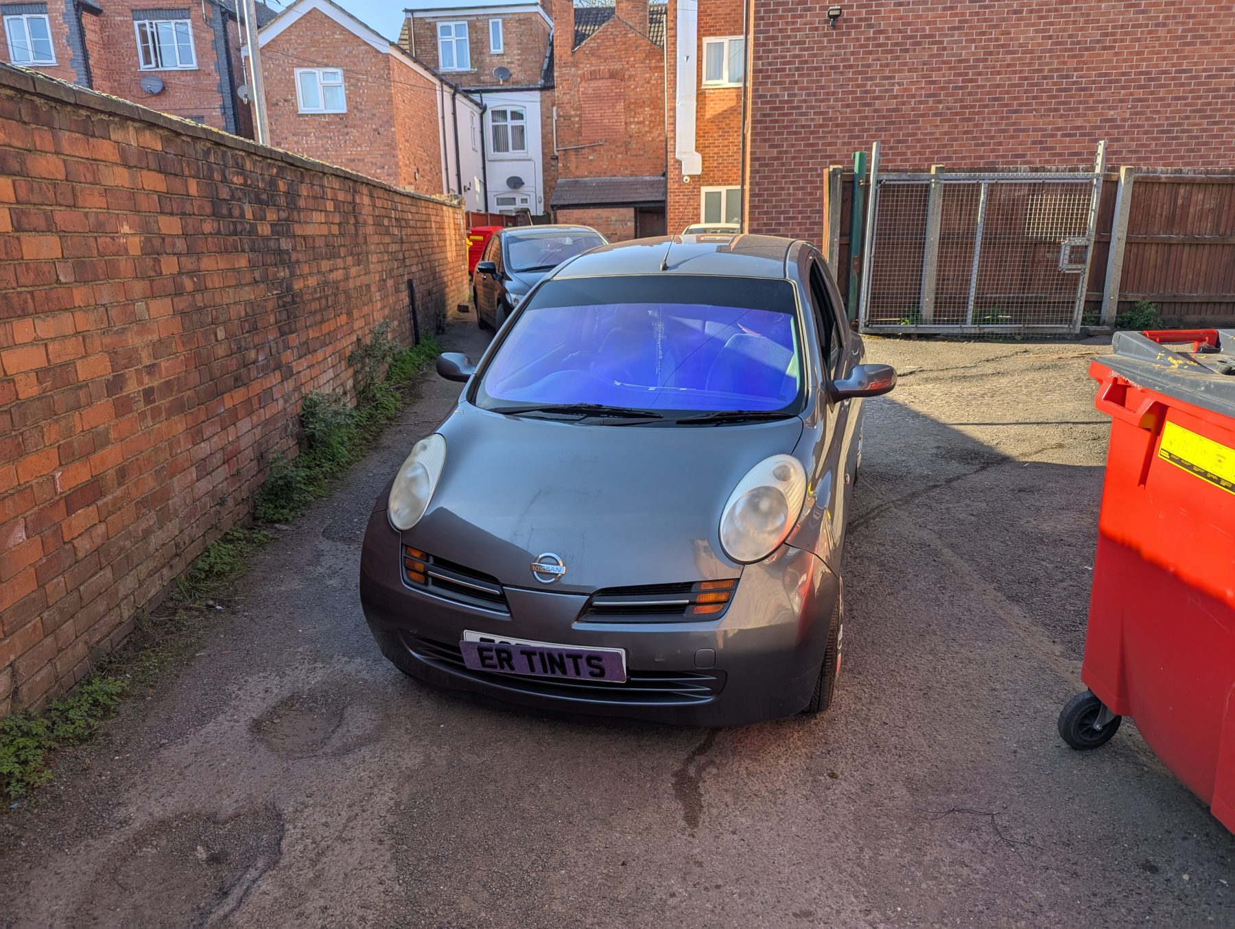 Chameleon Tinting Grey nissan micra fitted with gloss black sunstrip and blue chameleon windscreen
