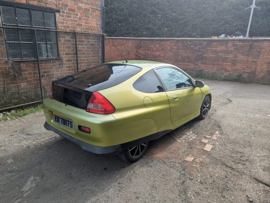 Green honda insight with 20% dark smoke tinted rear windows