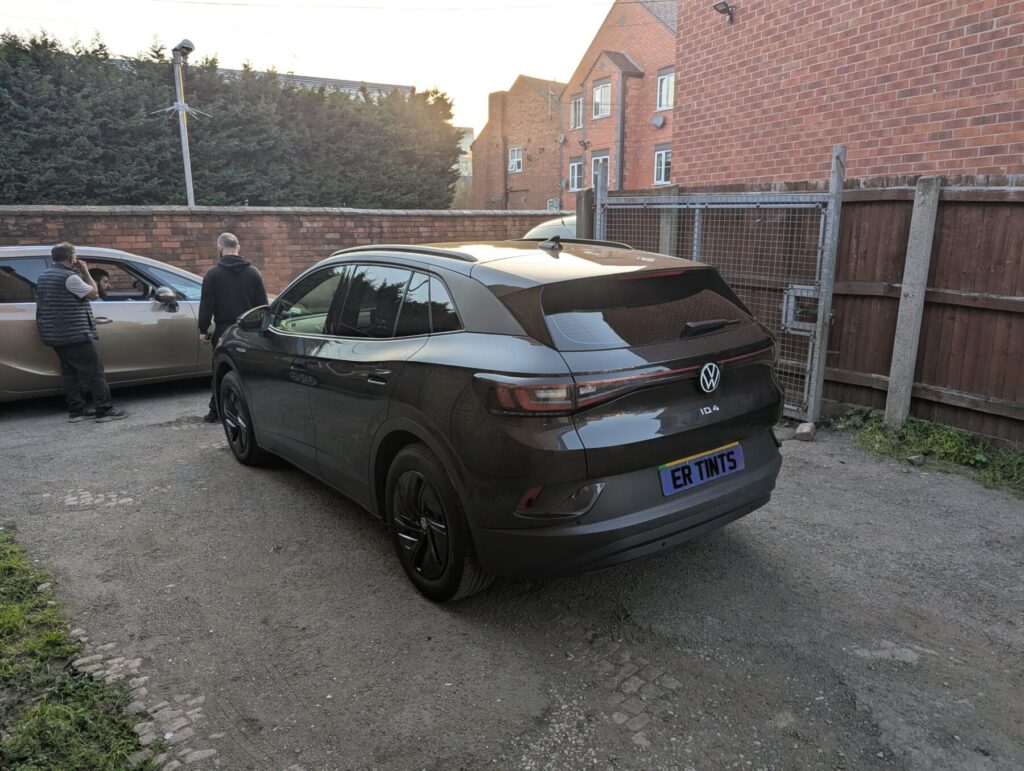 Grey volkswagen id4 with 20% dark smoke tinted rear windows