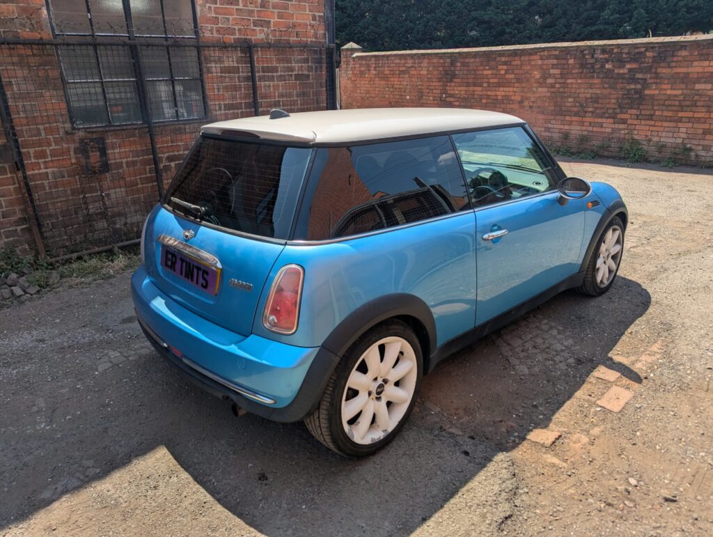 Light blue mini cooper with 5% limo tinted rear windows