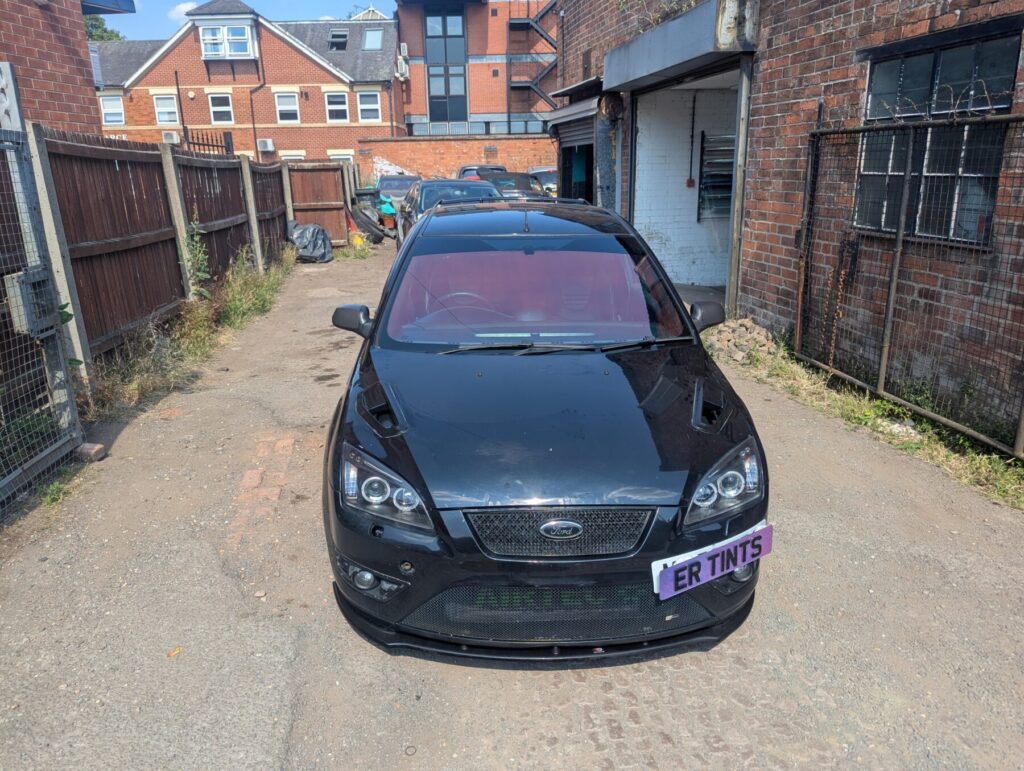 Black ford focus fitted with a ruby red chameleon windscreen