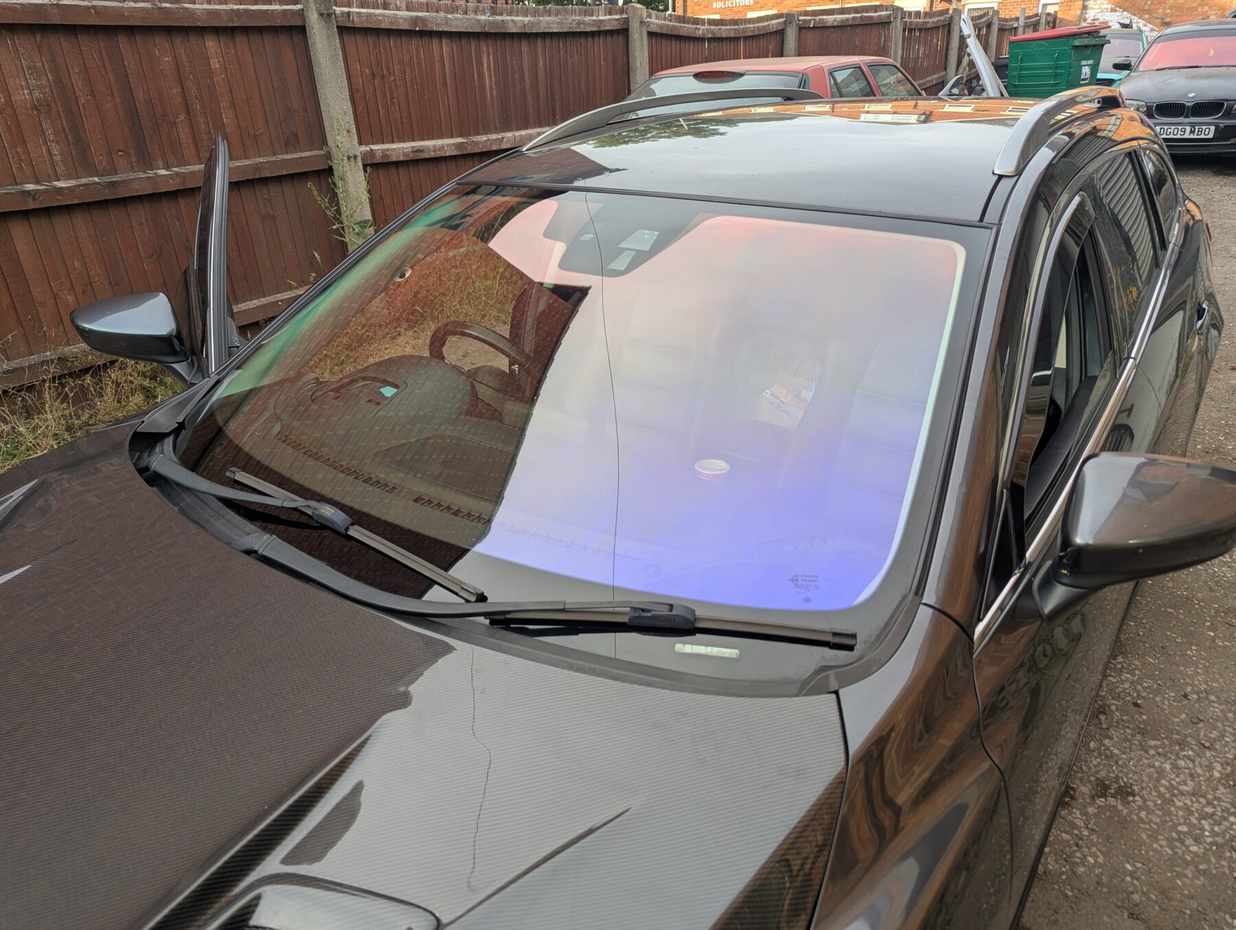 Chameleon Tinting a red and blue chameleon windscreen on gray car