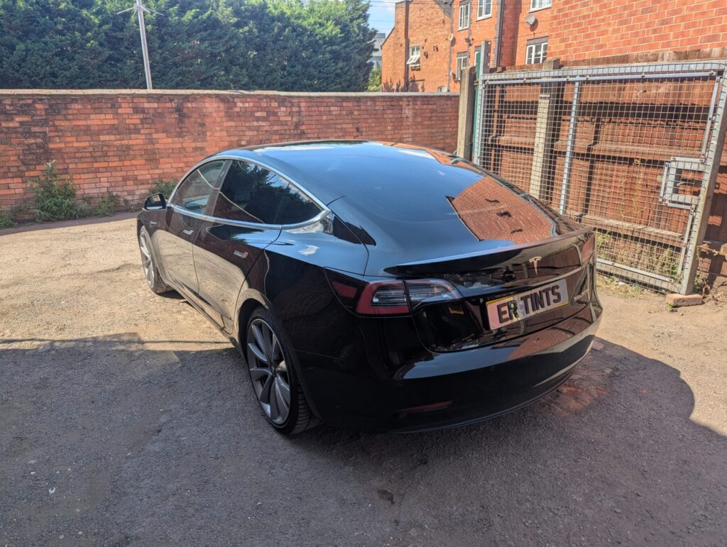 Black tesla model 3 with 5% limo tinted rear windows